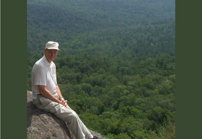 Art Franz sits on a rocky ledge at Cat Mountain. Click for Facebook post link.