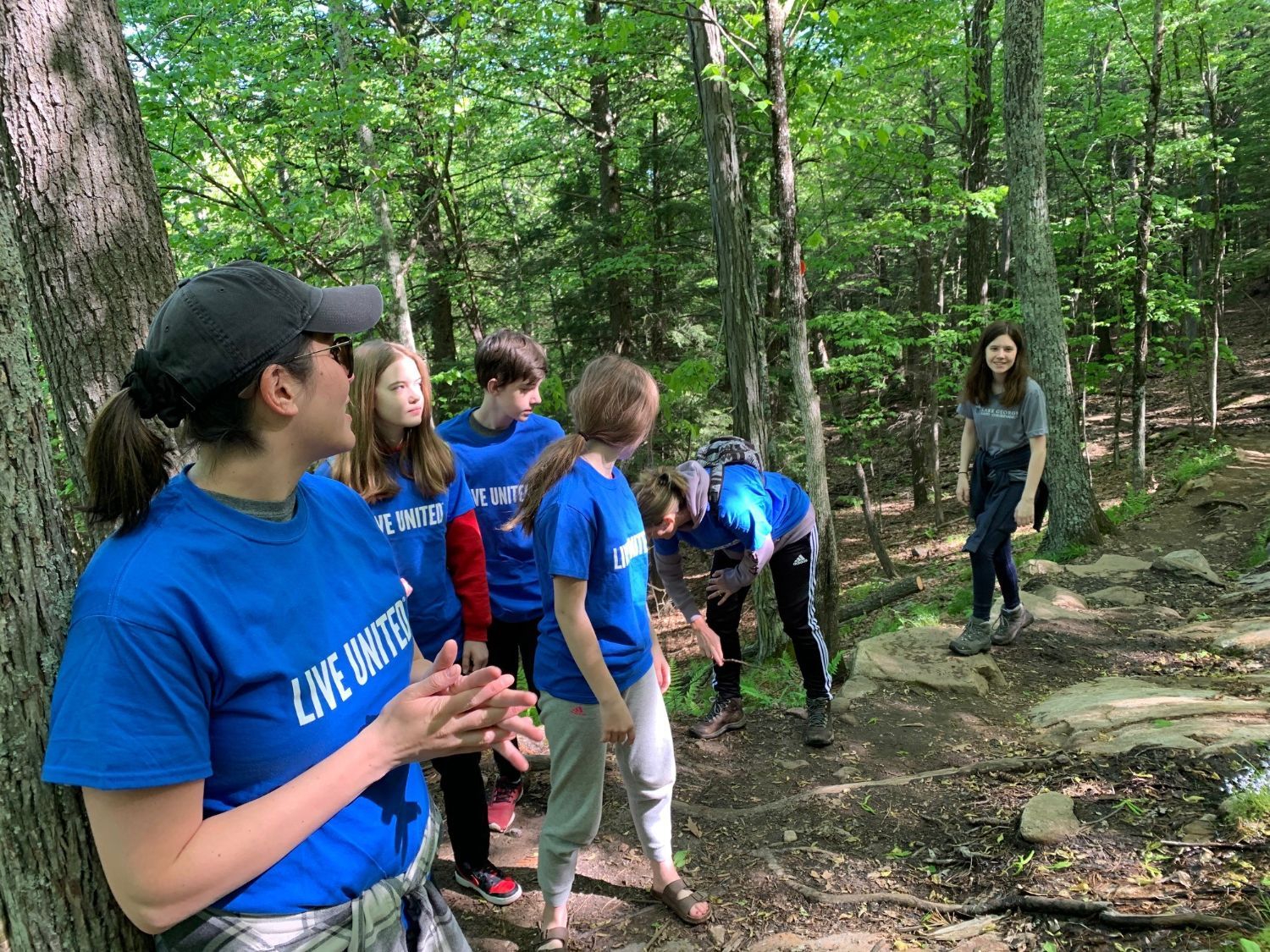 Grace Welles with volunteers on a trail at Pilot Knob.