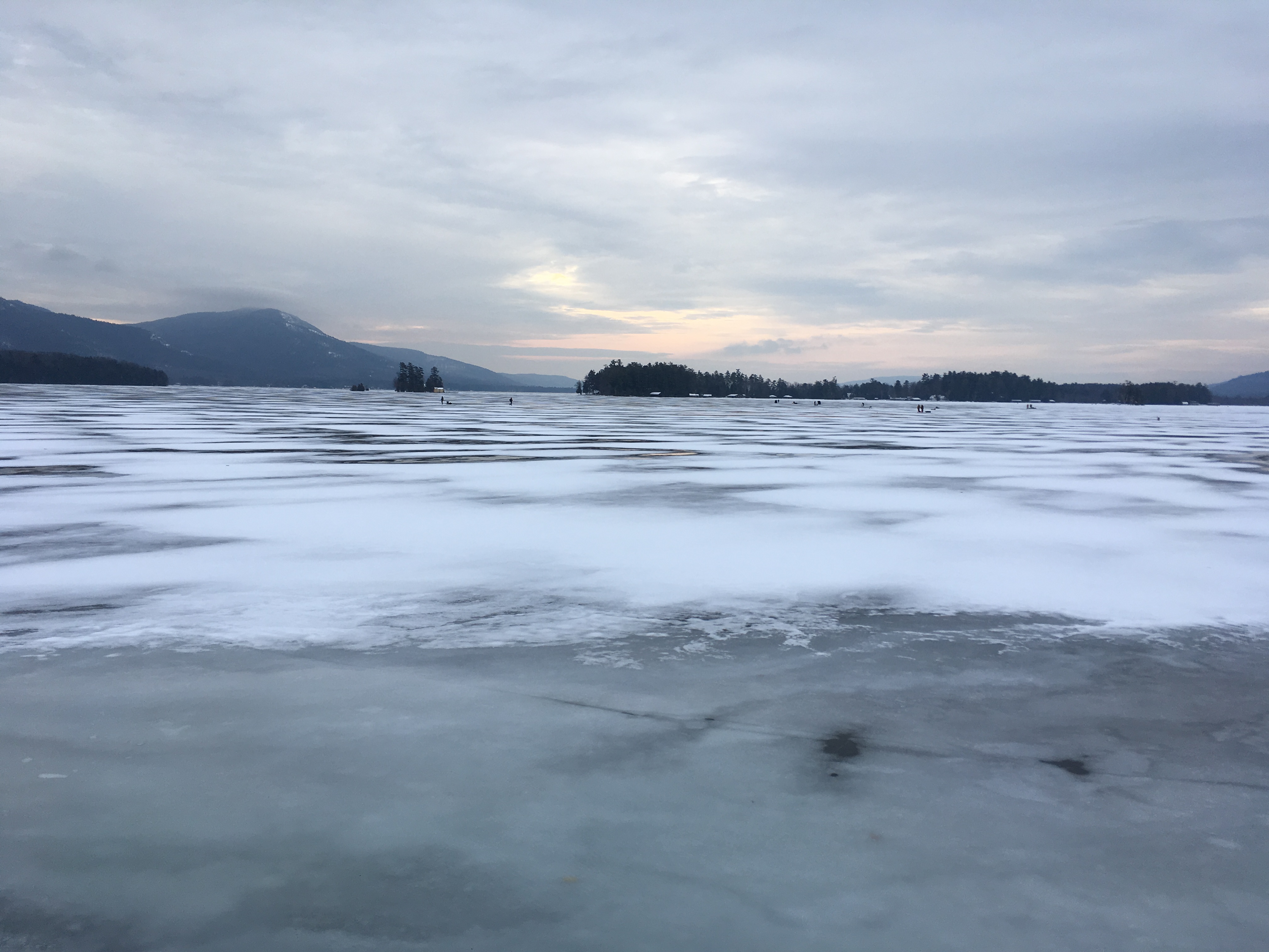 Morning on frozen Lake George with people ice fishing.