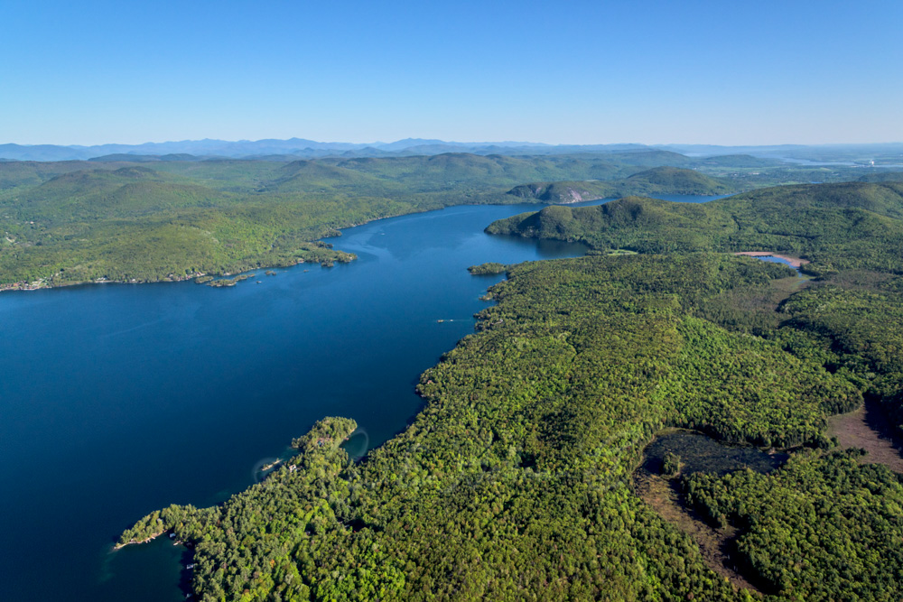 Aerial photo of northeastern Lake George, looking north, with Sucker Brook wetlands in the foreground, the lake, and Rogers Rock in the background.